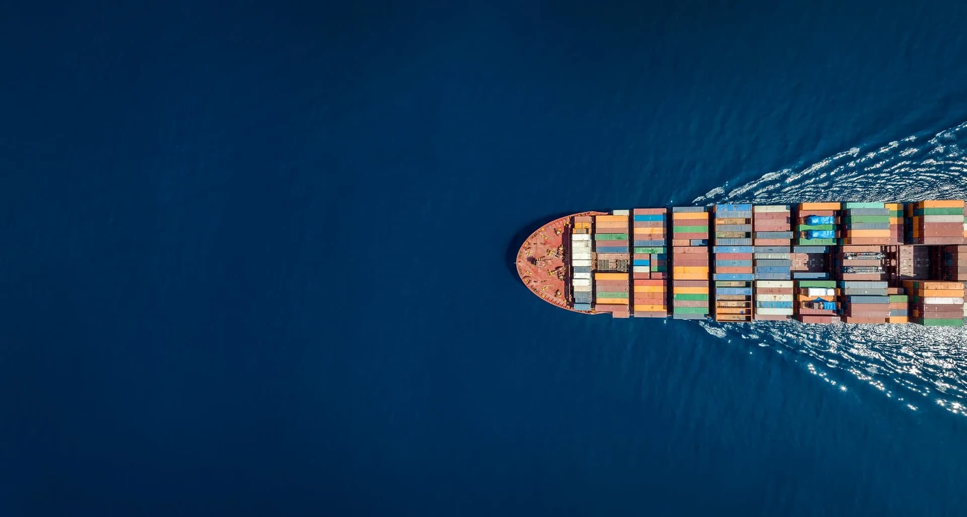 Top-down view of a container vessel at sea representing ESMARINE marine survey services